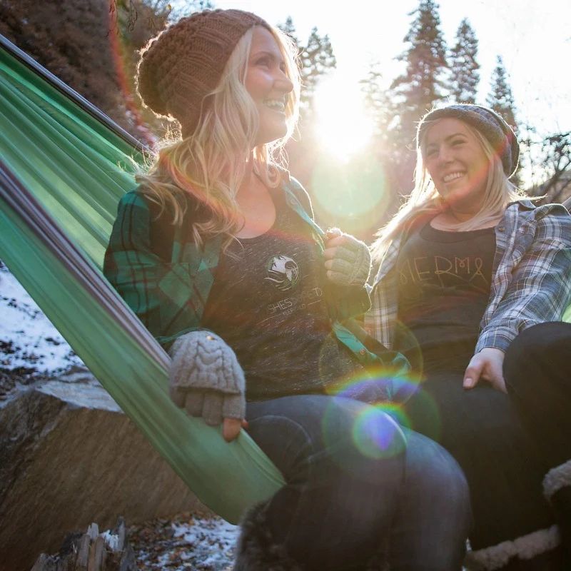 two women share a silver lime green camping hammock by wildhorn outfitters